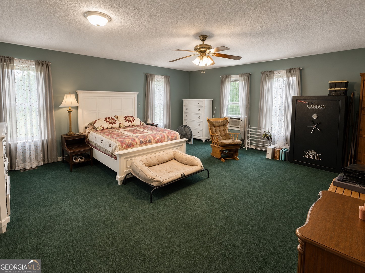 839 Cannafax Road Barnesville, GA 30204 - Photo 4 of 10 a spacious bedroom with a bed and a chandelier