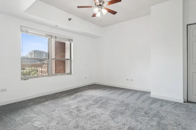 an empty room with closet and natural light