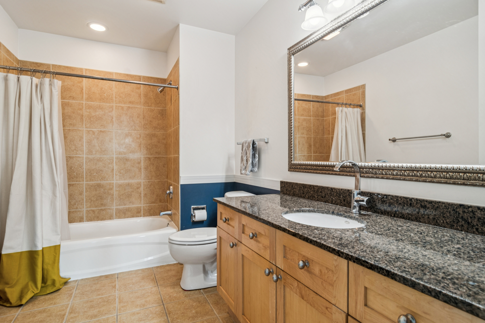 720 West Randolph Street, Unit 502 Chicago, IL 60661 - Photo 13 of 22 a bathroom with a granite countertop sink a toilet a mirror and shower
