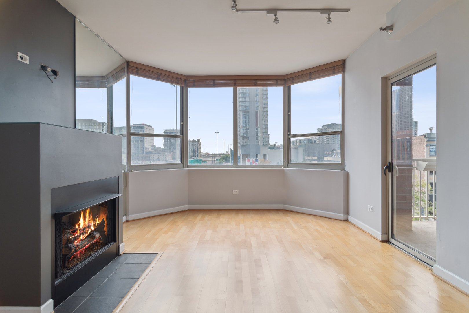 720 West Randolph Street, Unit 502 Chicago, IL 60661 - Photo 3 of 22 a view of an empty room with a fireplace and a window