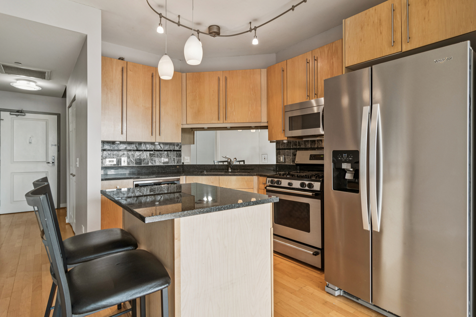 720 West Randolph Street, Unit 502 Chicago, IL 60661 - Photo 5 of 22 a kitchen with stainless steel appliances granite countertop a stove refrigerator and a sink
