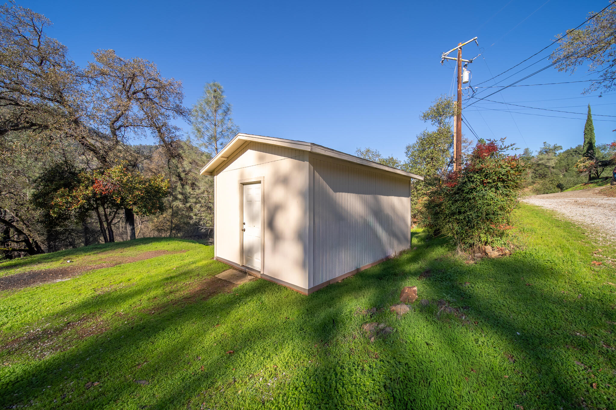 Undisclosed Address Redding, CA 96003 - Photo 18 of 39 a view of a backyard with a house in the background