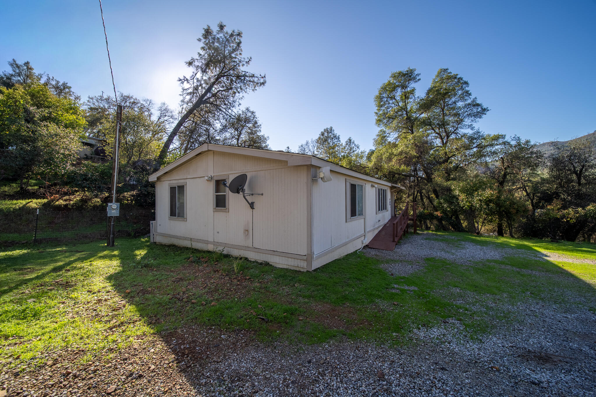 Undisclosed Address Redding, CA 96003 - Photo 25 of 39 a white house that has tree in front of it