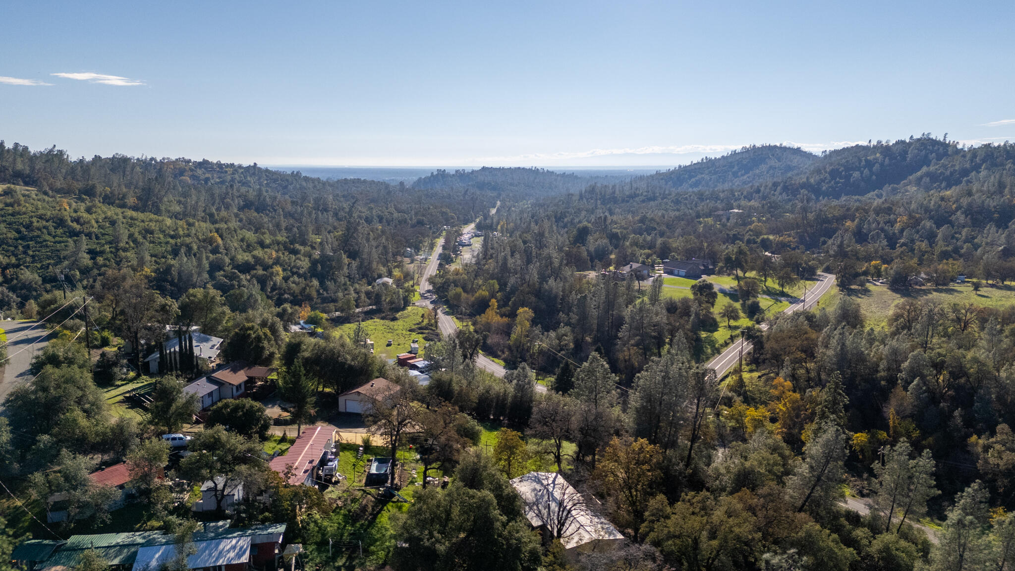 Undisclosed Address Redding, CA 96003 - Photo 33 of 39 an aerial view of house with green field and mountains