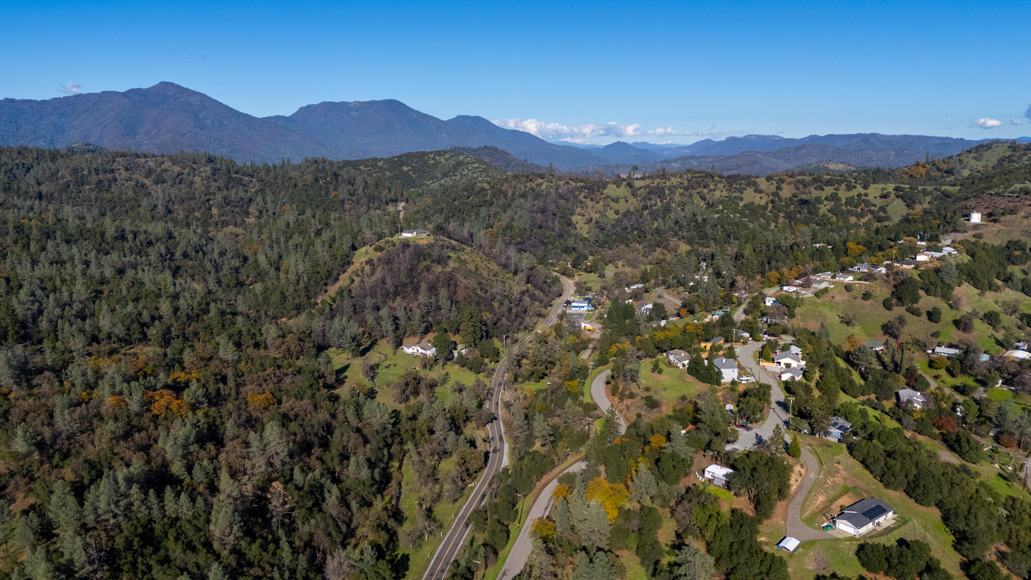 Undisclosed Address Redding, CA 96003 - Photo 34 of 39 a view of a lush green hillside and a houses