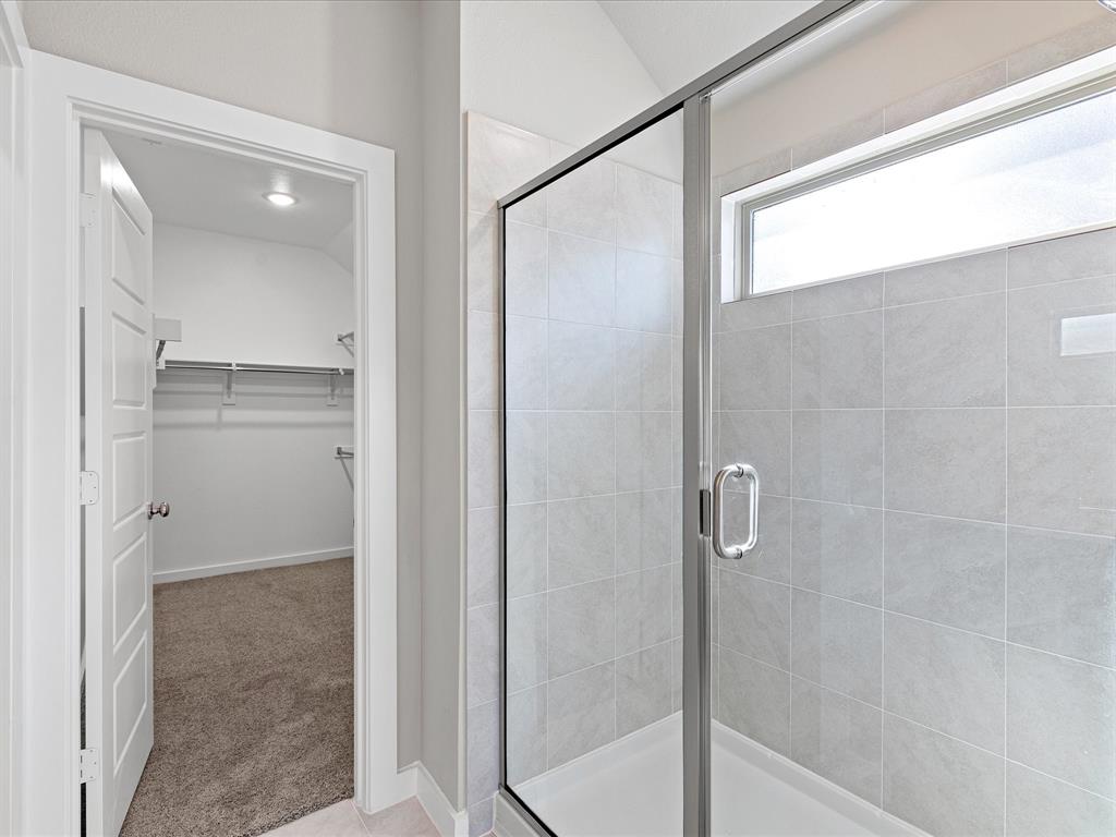 643 Medinah Road Red Oak, TX 75154 - Photo 15 of 28 a bathroom with a glass shower door
