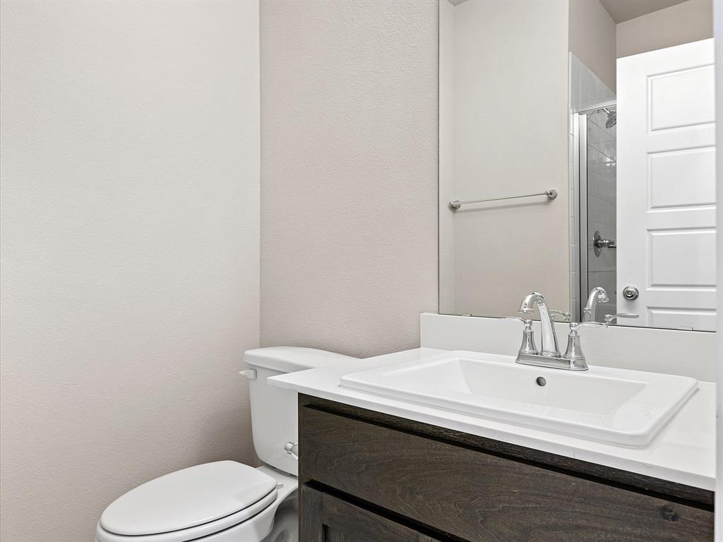 643 Medinah Road Red Oak, TX 75154 - Photo 24 of 28 a bathroom with a sink a toilet and mirror