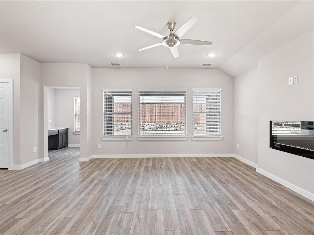 643 Medinah Road Red Oak, TX 75154 - Photo 6 of 28 a view of an empty room with a window and wooden floor