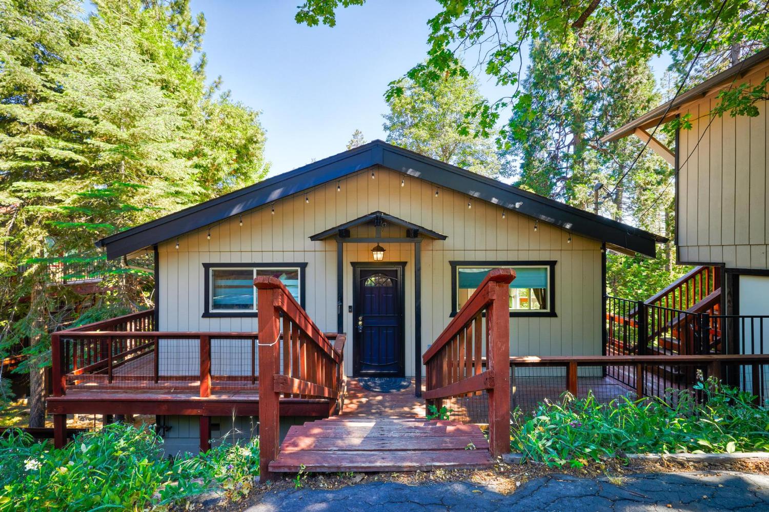 24033 Pine Cone Road Mi Wuk Village, CA 95346 - Photo 1 of 80 a front view of a house with garden