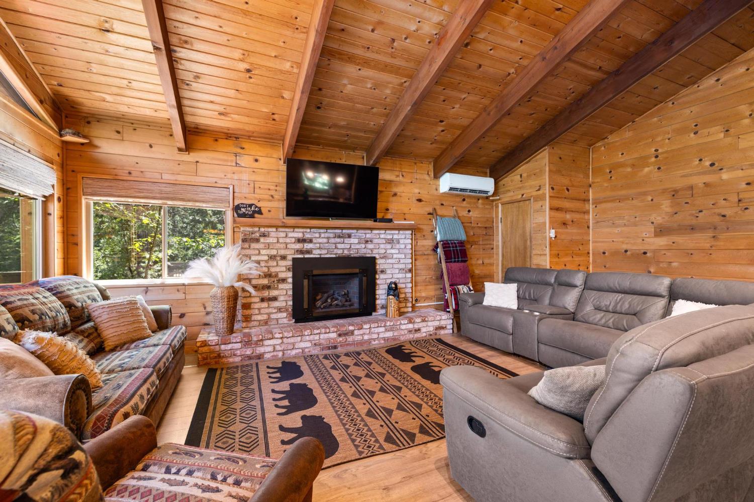 24033 Pine Cone Road Mi Wuk Village, CA 95346 - Photo 13 of 80 a living room with furniture a flat screen tv and a fireplace
