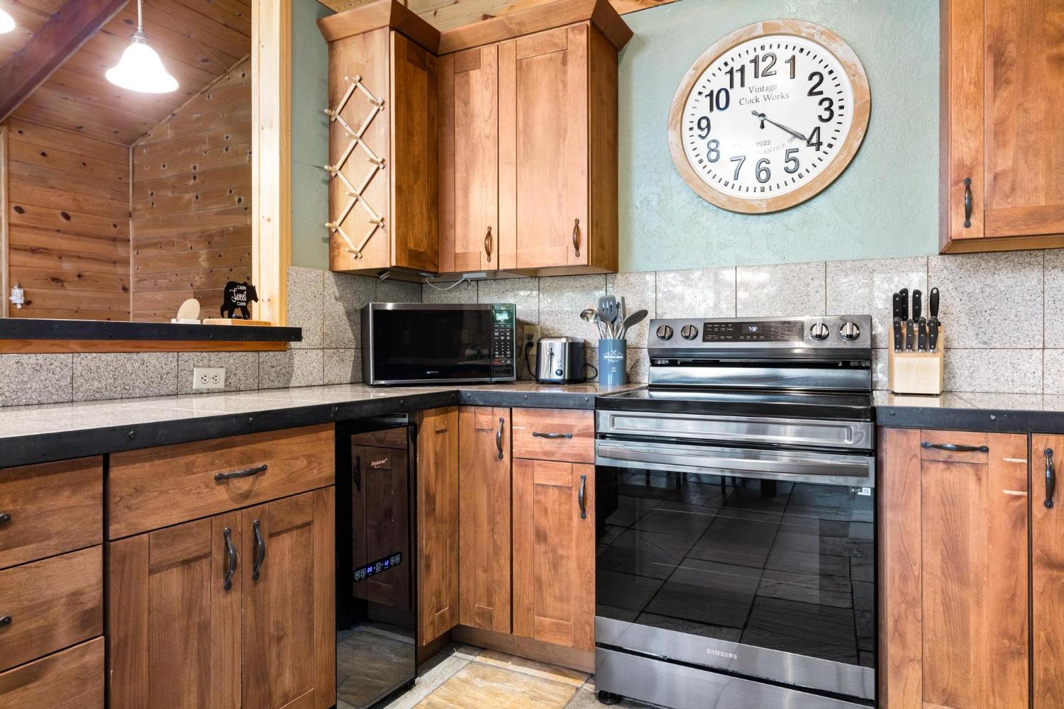 24033 Pine Cone Road Mi Wuk Village, CA 95346 - Photo 22 of 80 a stove top oven sitting inside of a kitchen