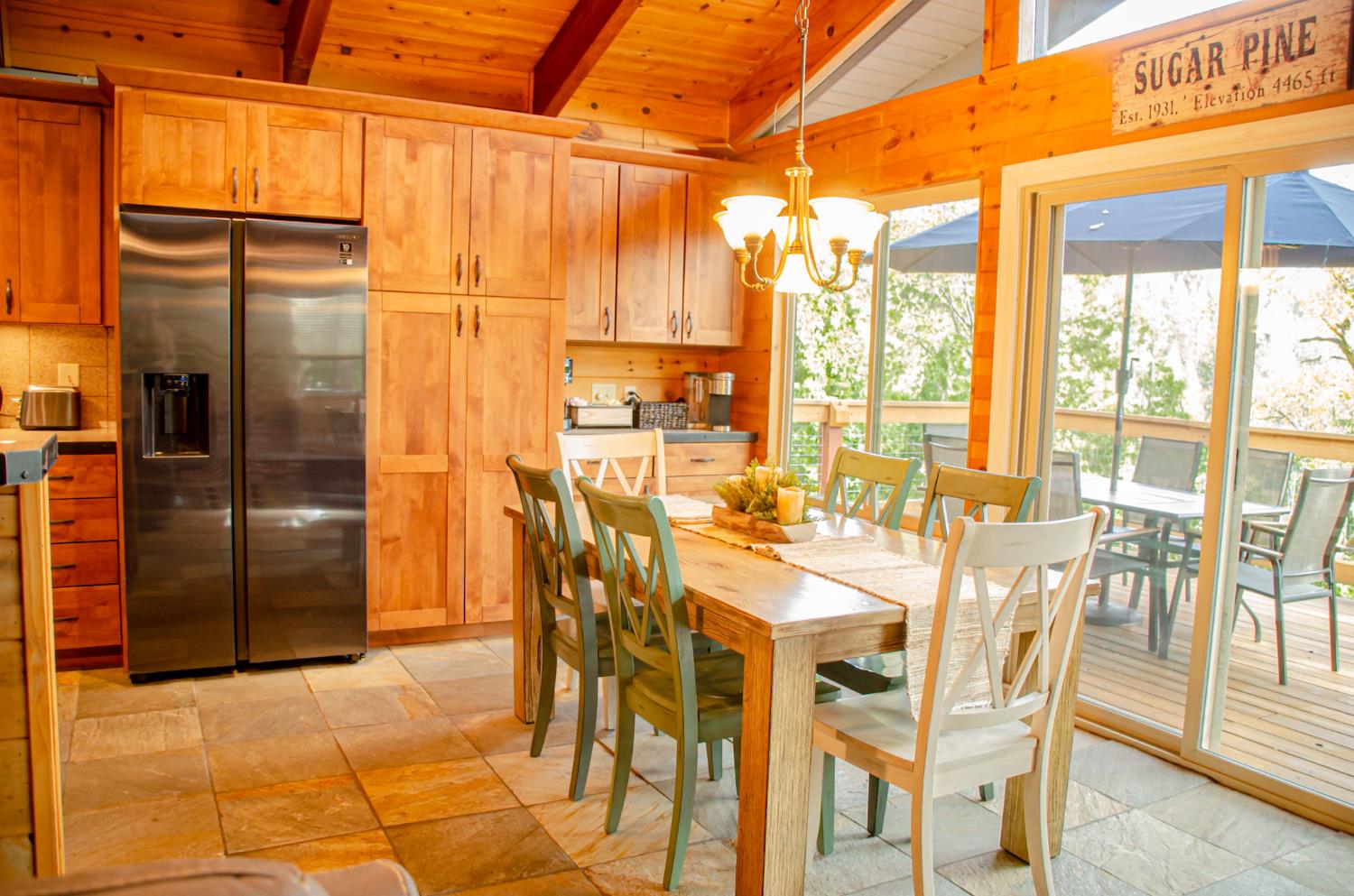 24033 Pine Cone Road Mi Wuk Village, CA 95346 - Photo 24 of 80 a view of a dining room with furniture a chandelier and glass door