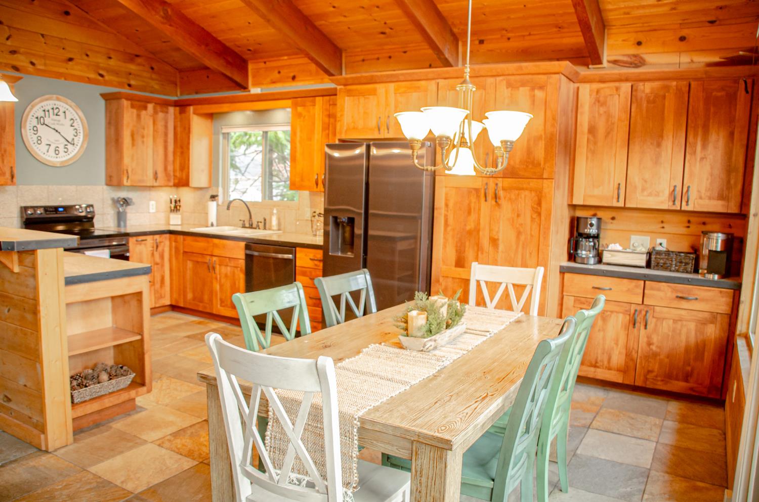 24033 Pine Cone Road Mi Wuk Village, CA 95346 - Photo 25 of 80 a view of a kitchen with kitchen island granite countertop wooden floor and stainless steel appliances