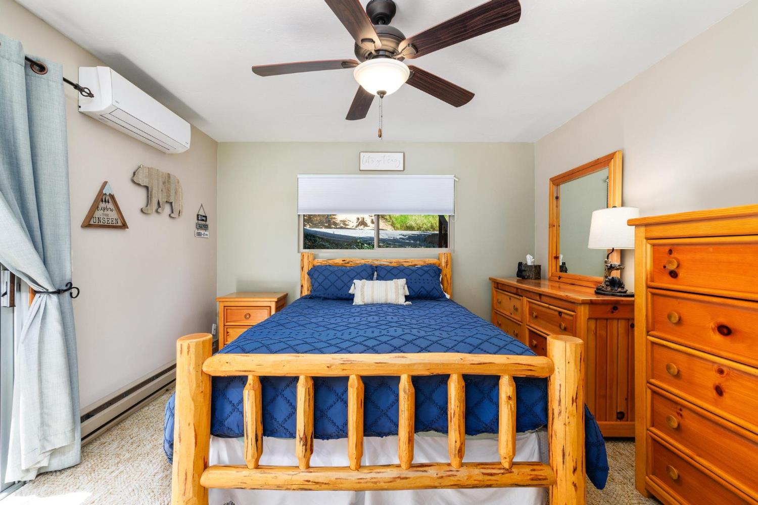 24033 Pine Cone Road Mi Wuk Village, CA 95346 - Photo 31 of 80 a bedroom with a bed and a chandelier