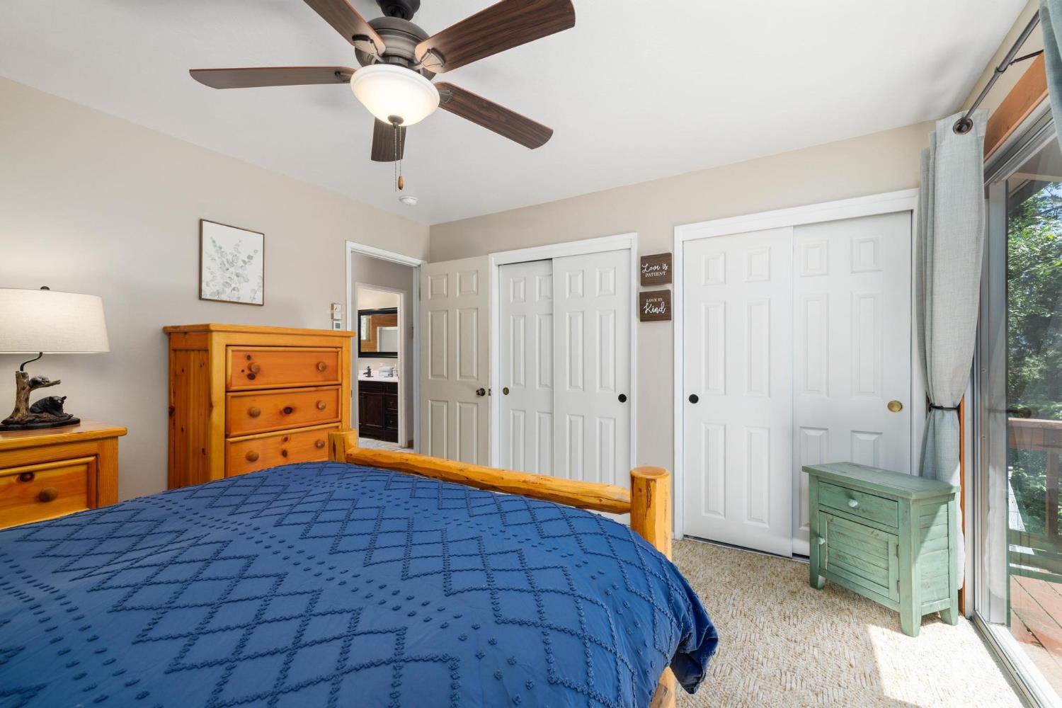 24033 Pine Cone Road Mi Wuk Village, CA 95346 - Photo 32 of 80 a bedroom with a bed and a chandelier