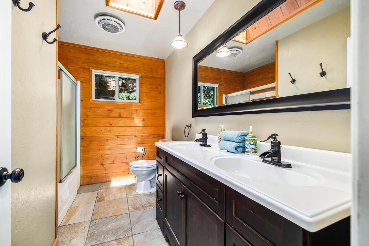 24033 Pine Cone Road Mi Wuk Village, CA 95346 - Photo 34 of 80 a bathroom with a sink a toilet and mirror