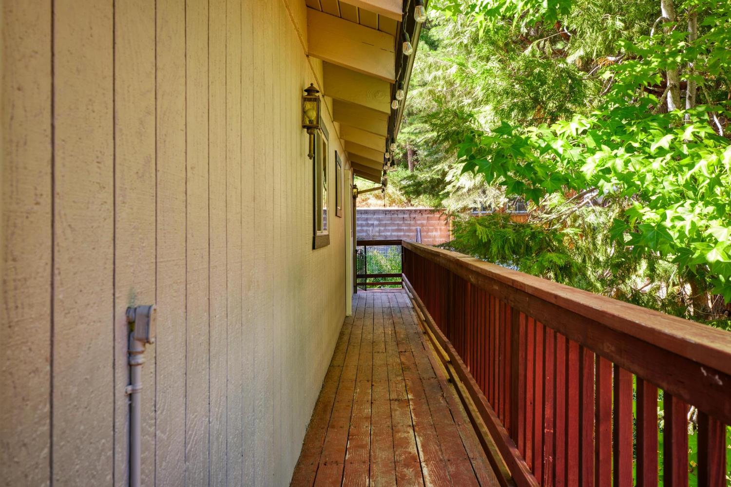 24033 Pine Cone Road Mi Wuk Village, CA 95346 - Photo 52 of 80 a view of balcony with wooden floor and fence