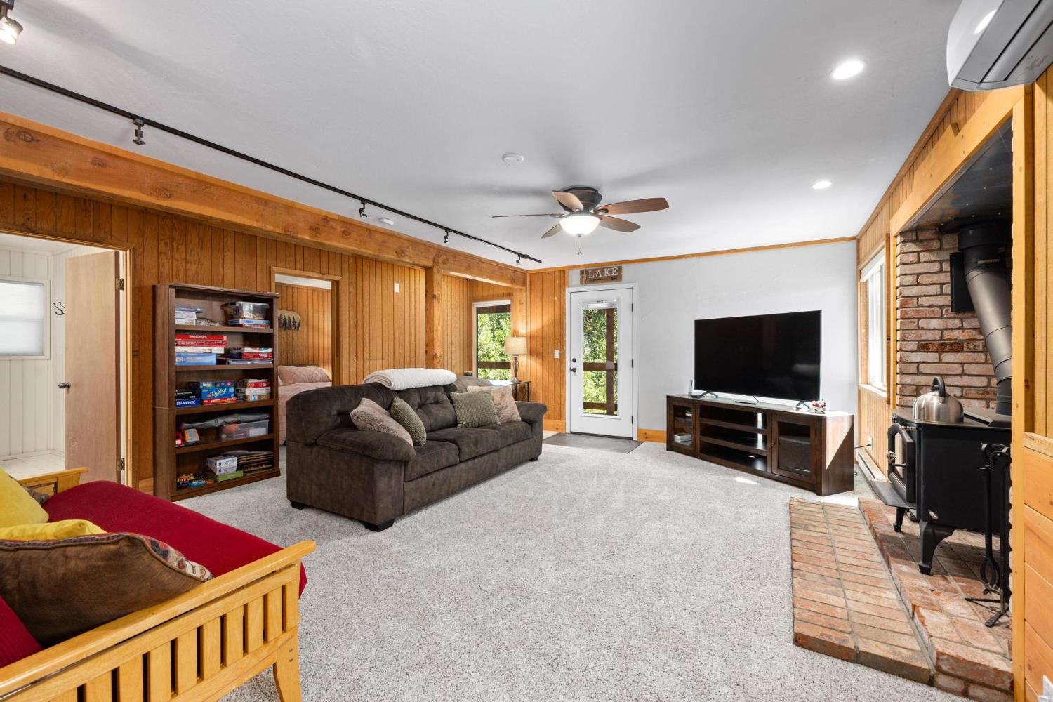 24033 Pine Cone Road Mi Wuk Village, CA 95346 - Photo 54 of 80 a living room with furniture and a flat screen tv