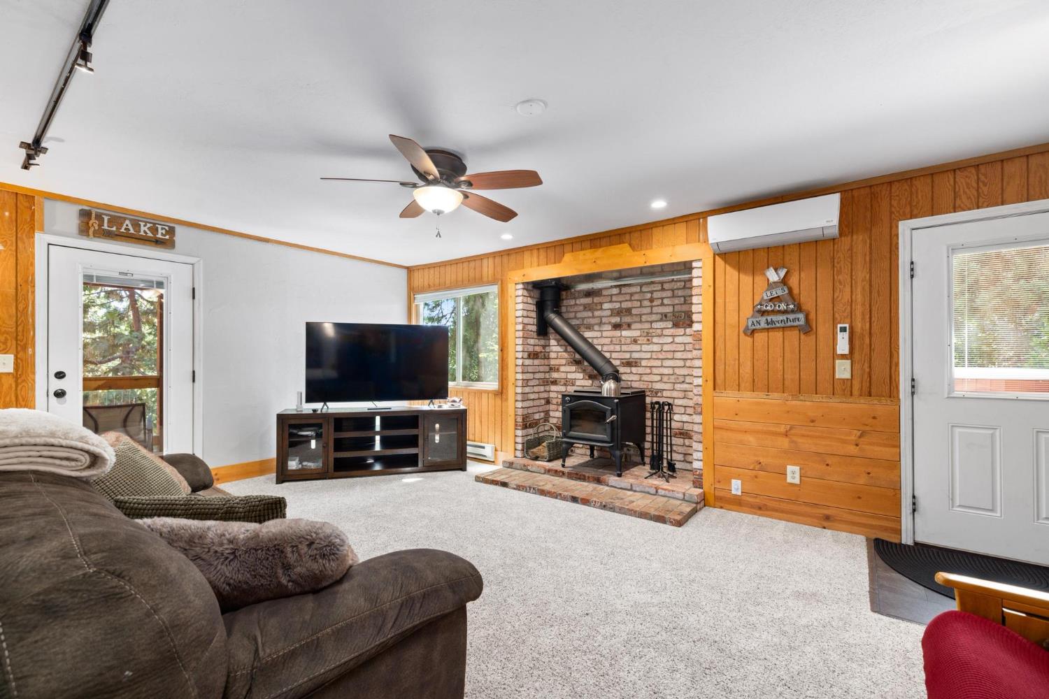 24033 Pine Cone Road Mi Wuk Village, CA 95346 - Photo 55 of 80 a living room with furniture and a flat screen tv