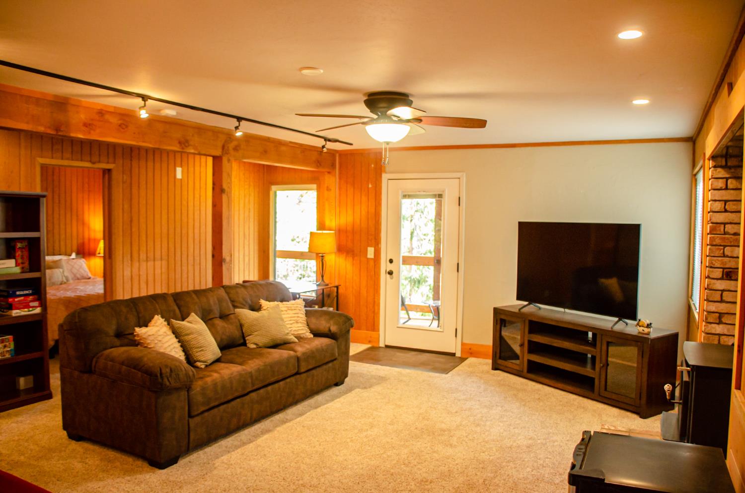 24033 Pine Cone Road Mi Wuk Village, CA 95346 - Photo 56 of 80 a living room with furniture and a flat screen tv