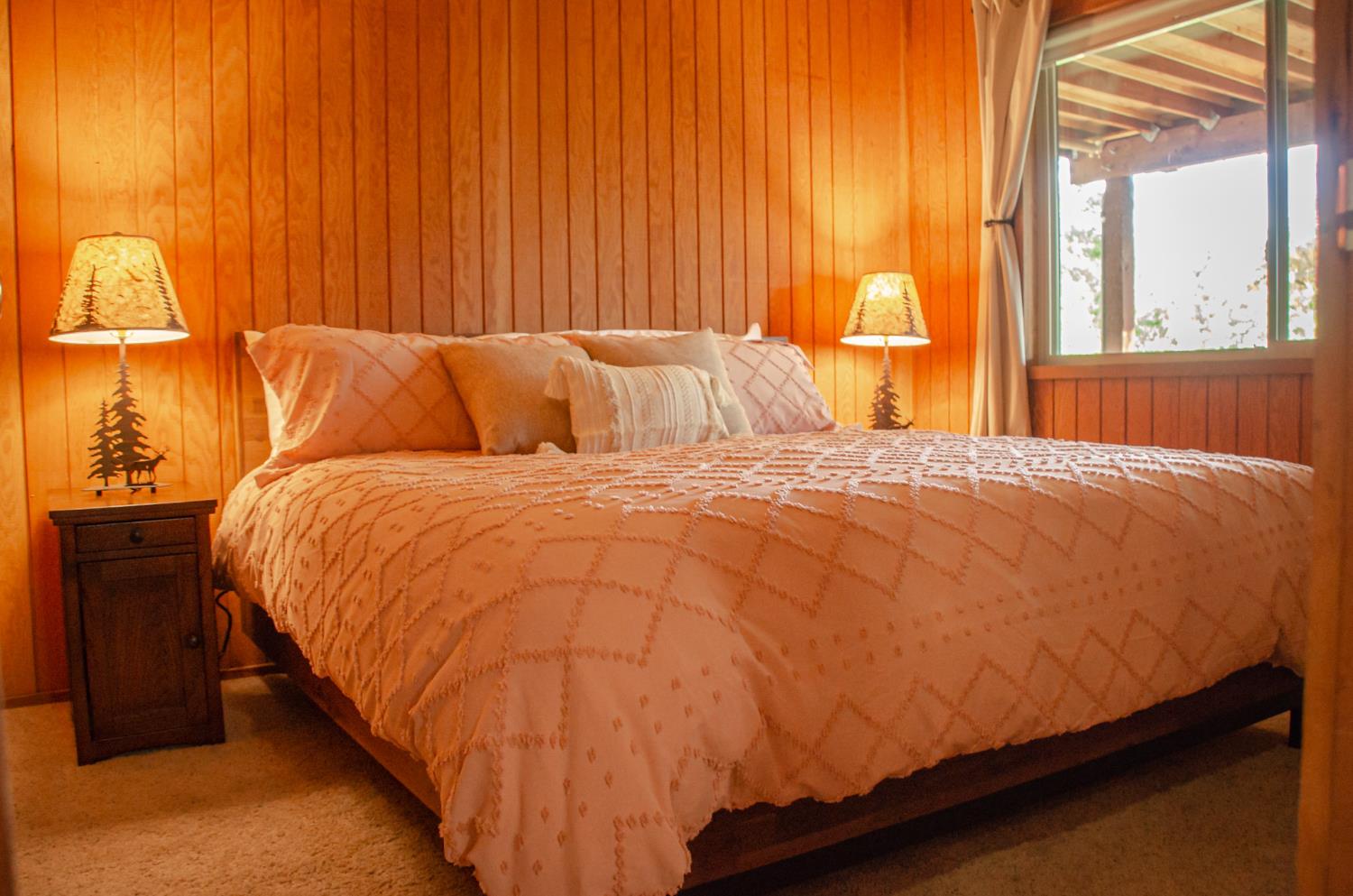 24033 Pine Cone Road Mi Wuk Village, CA 95346 - Photo 66 of 80 a large bed sitting in a bedroom next to a window