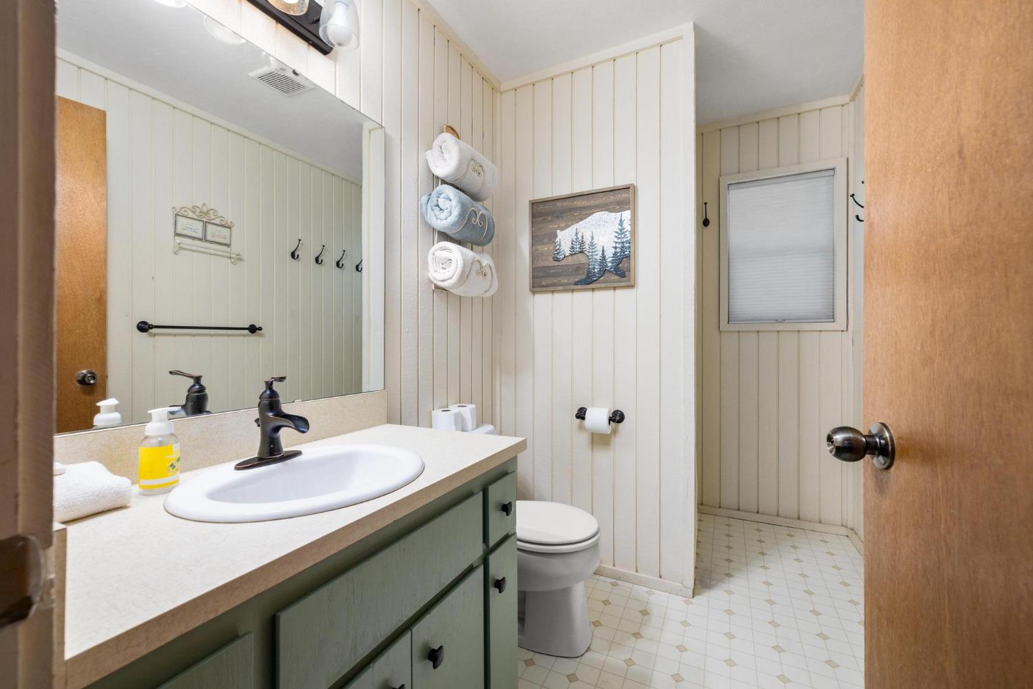 24033 Pine Cone Road Mi Wuk Village, CA 95346 - Photo 68 of 80 a bathroom with a sink and a mirror