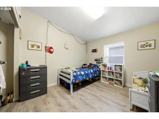 a bedroom with furniture and a wooden floor