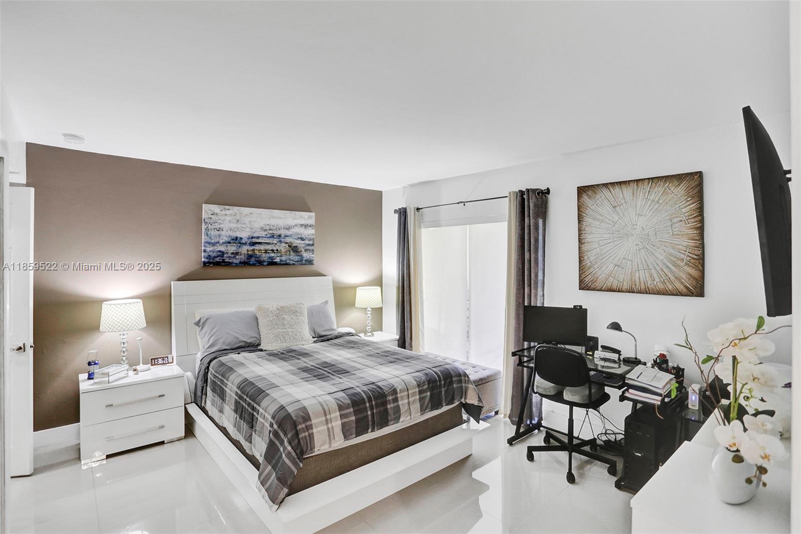 8401 Southwest 107th Avenue, Unit 111E Miami, FL 33173 - Photo 12 of 31 a bedroom with a bed and wooden floor