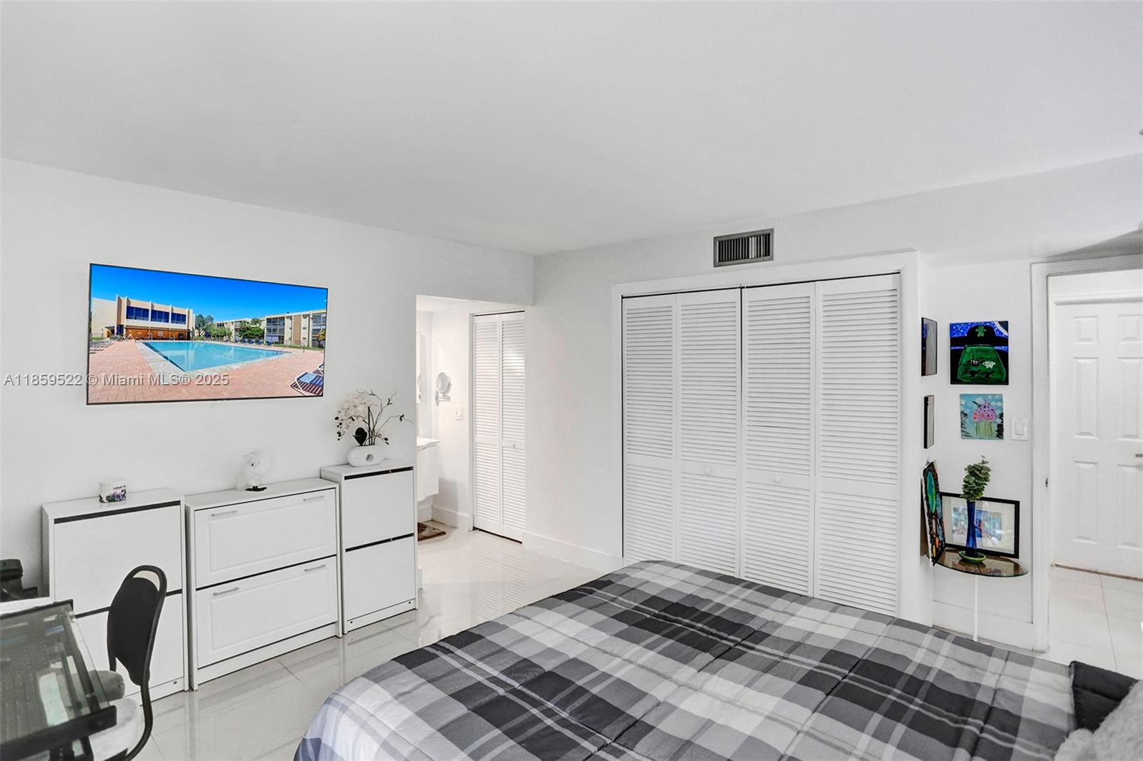 8401 Southwest 107th Avenue, Unit 111E Miami, FL 33173 - Photo 14 of 31 a workspace with white cabinets and wooden floor