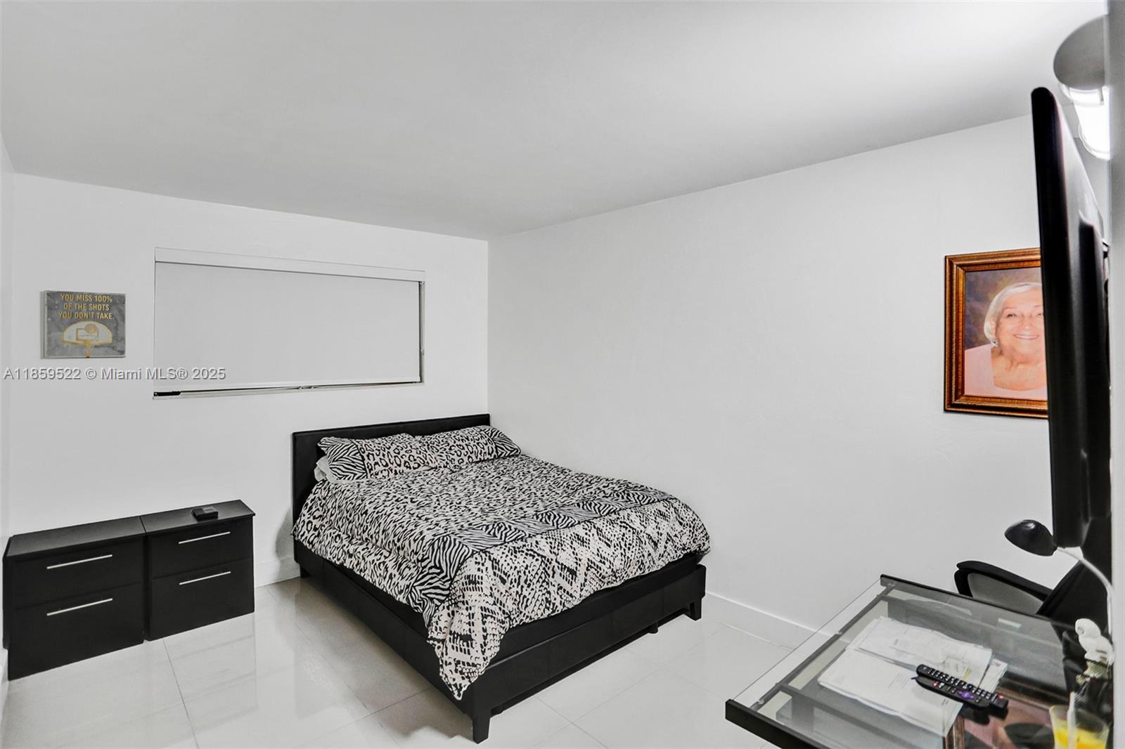 8401 Southwest 107th Avenue, Unit 111E Miami, FL 33173 - Photo 16 of 31 a bedroom with a bed and a dresser in it