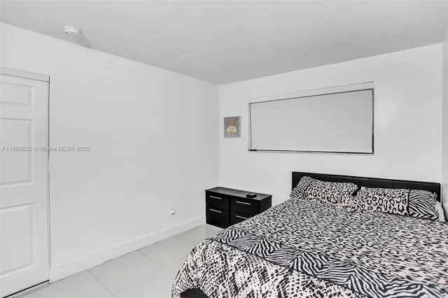 a bedroom with a bed and cabinets