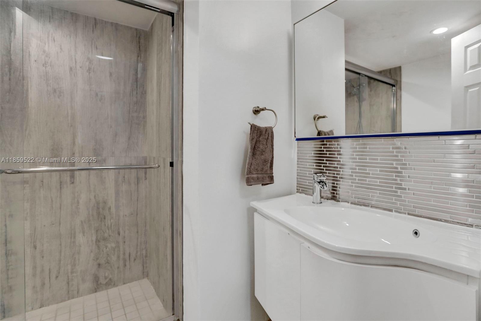 8401 Southwest 107th Avenue, Unit 111E Miami, FL 33173 - Photo 19 of 31 a bathroom with a shower and a sink