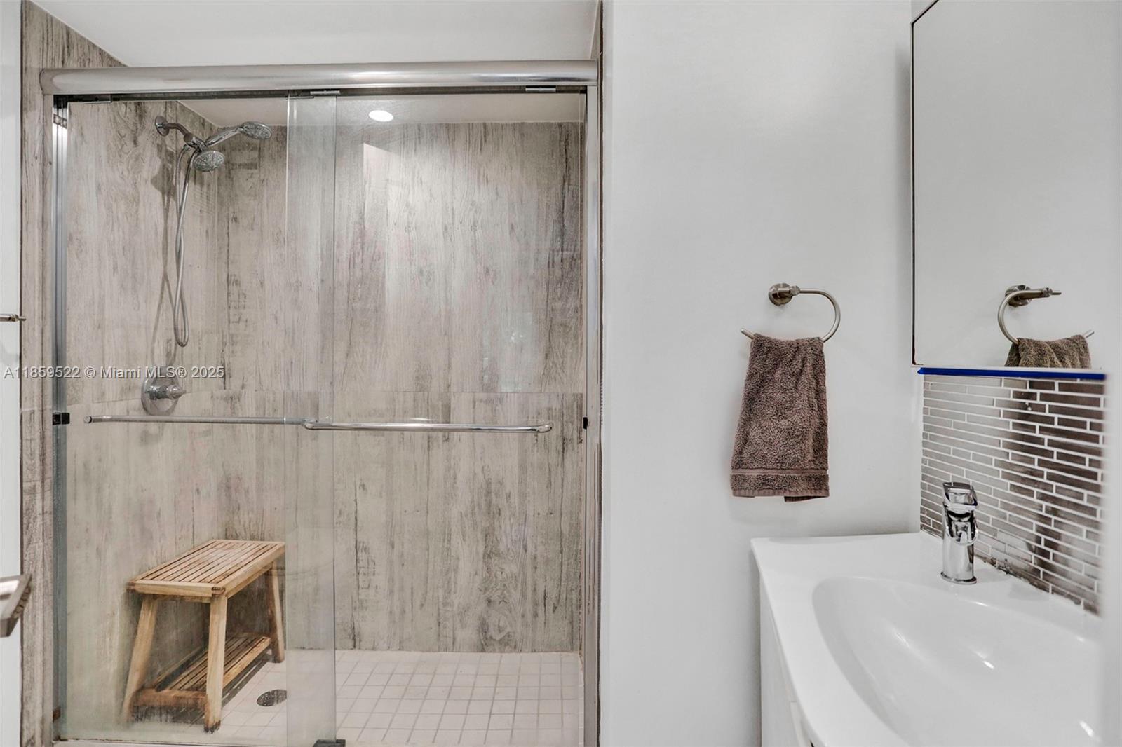 8401 Southwest 107th Avenue, Unit 111E Miami, FL 33173 - Photo 20 of 31 a bathroom with a shower curtain and a sink