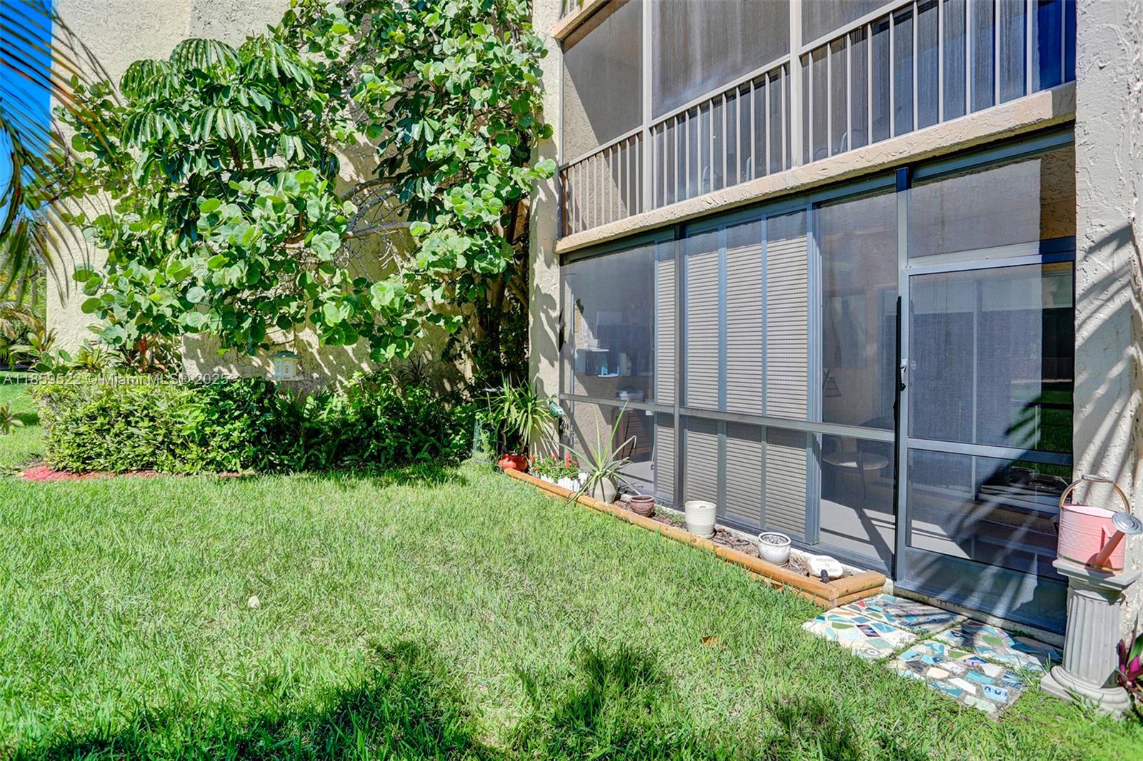 8401 Southwest 107th Avenue, Unit 111E Miami, FL 33173 - Photo 26 of 31 a view of backyard with potted plants and wooden fence