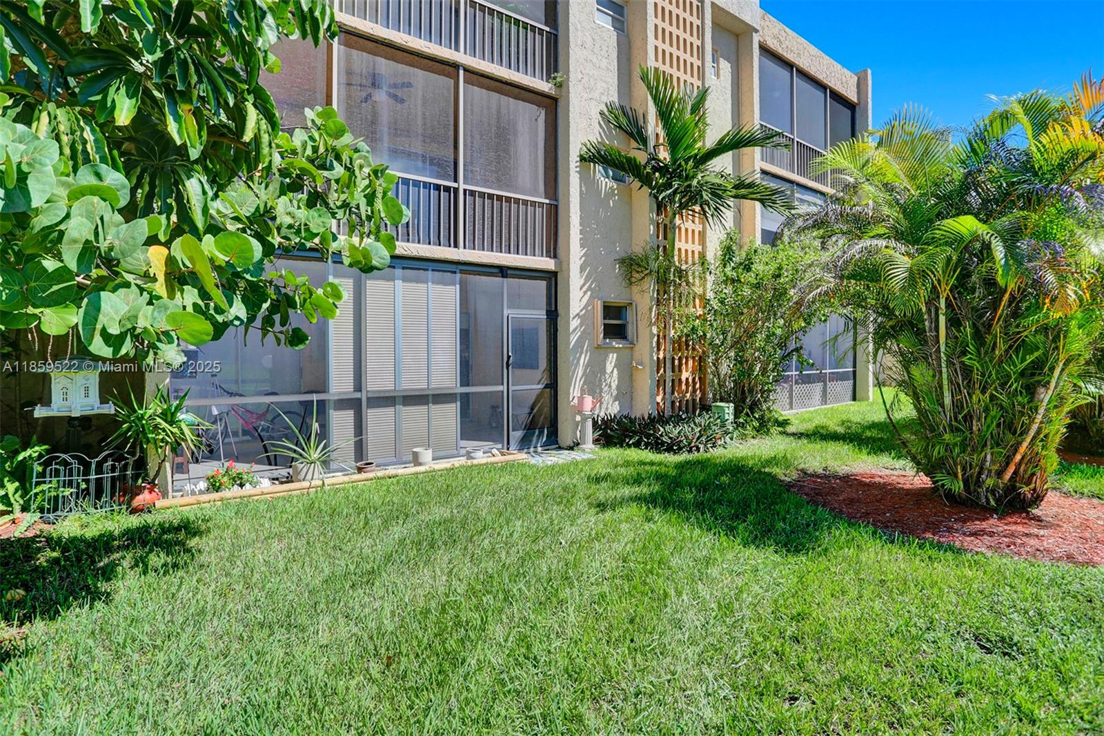 8401 Southwest 107th Avenue, Unit 111E Miami, FL 33173 - Photo 27 of 31 a view of a house with a yard and plants