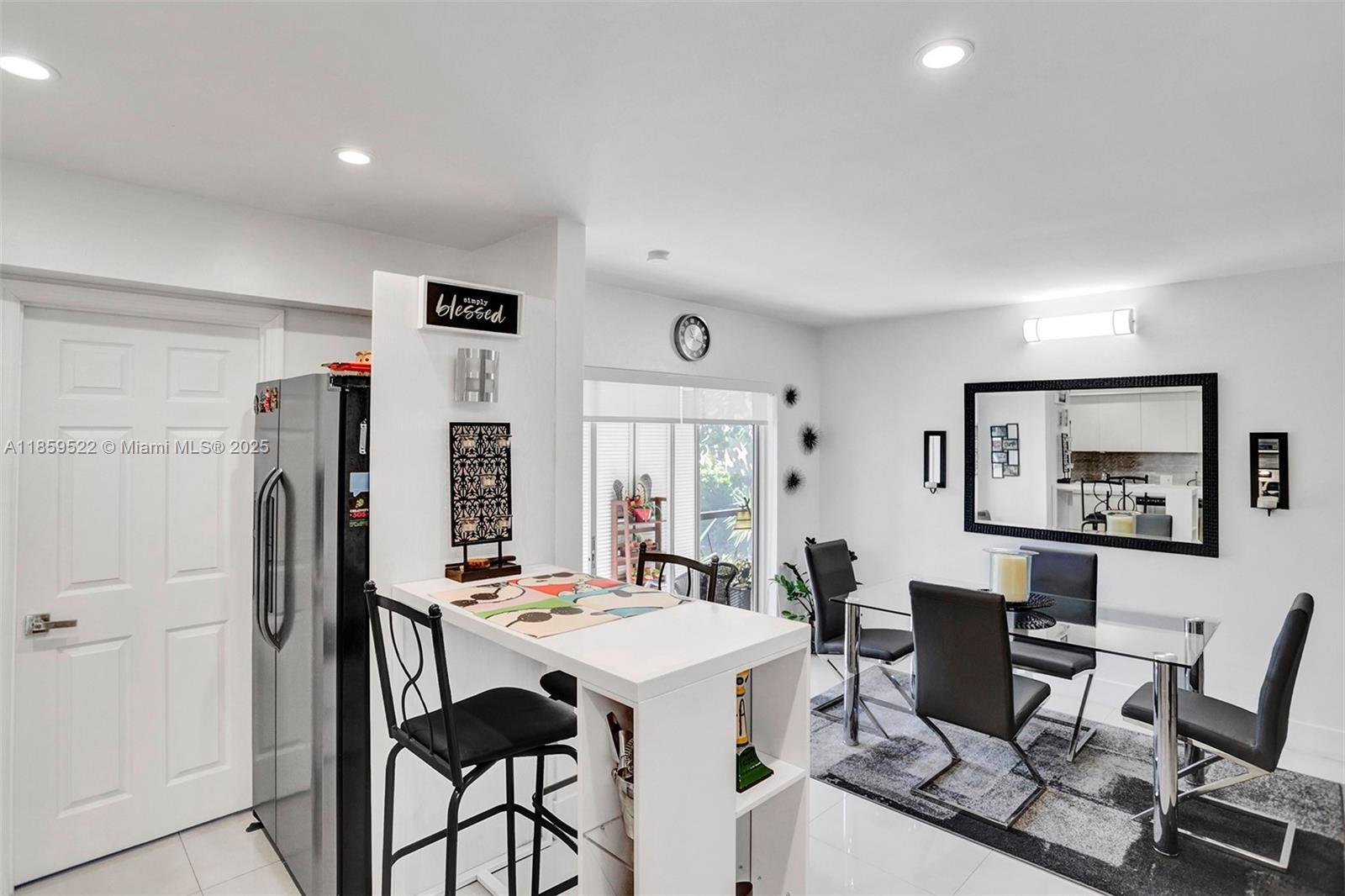 8401 Southwest 107th Avenue, Unit 111E Miami, FL 33173 - Photo 8 of 31 a view of a dining room with furniture and chandelier
