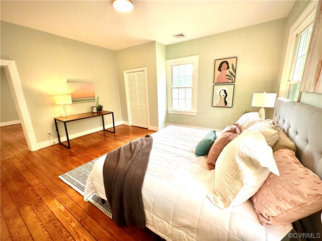 302 Main Street West Point, VA 23181 - Photo 14 of 24 a bedroom with a bed and wooden floor