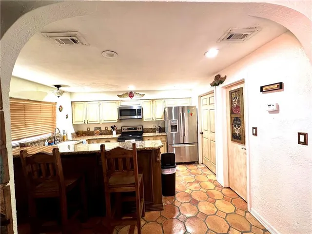 a dining table with chairs and window