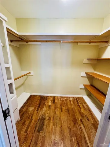 a view of a room with wooden floor