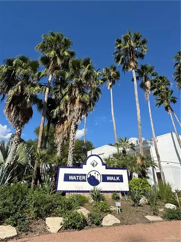 a sign that is sitting on a brick wall