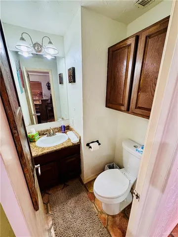 a bathroom with a sink and mirror with toilet