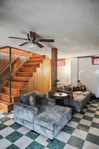 a living room with furniture a fireplace and a chandelier