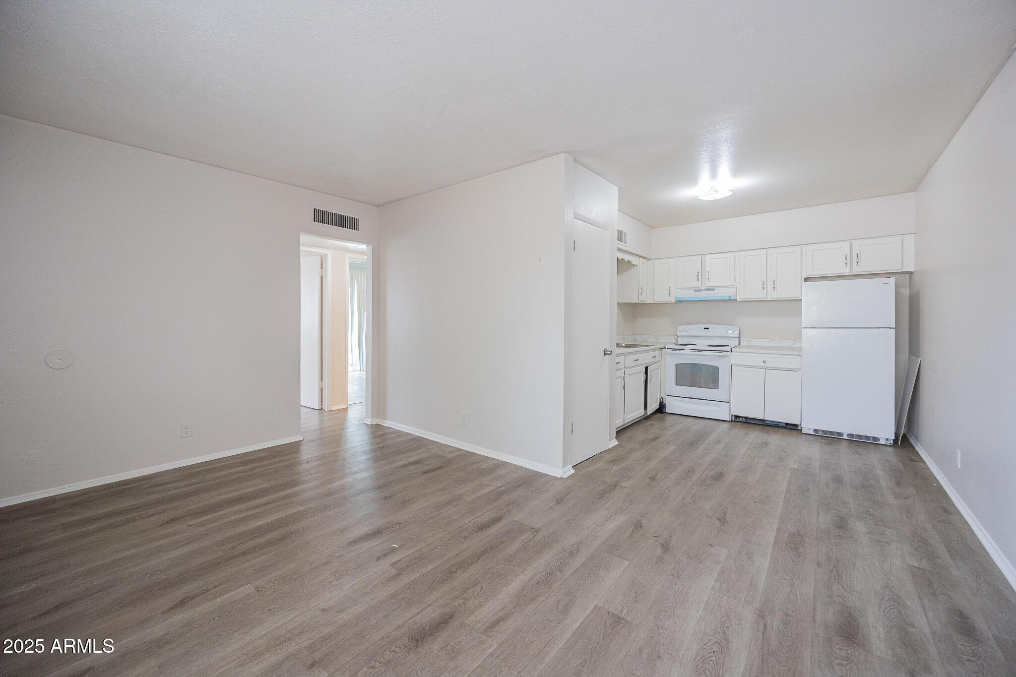 2352 East Broadway Road, Unit A Mesa, AZ 85204 - Photo 2 of 14 a view of a kitchen with wooden floor and electronic appliances
