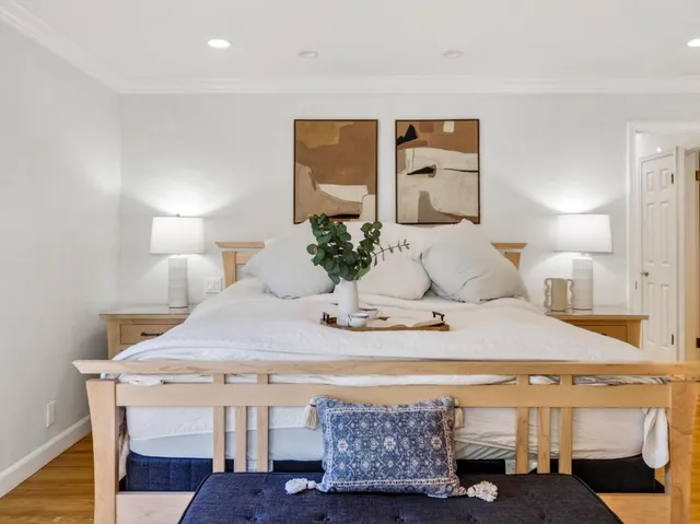 a living room with furniture a flat screen tv and a window