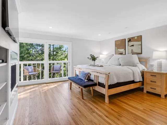 a spacious bathroom with a granite countertop sink a large mirror and a window