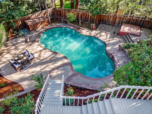 a view of a house with backyard and sitting area