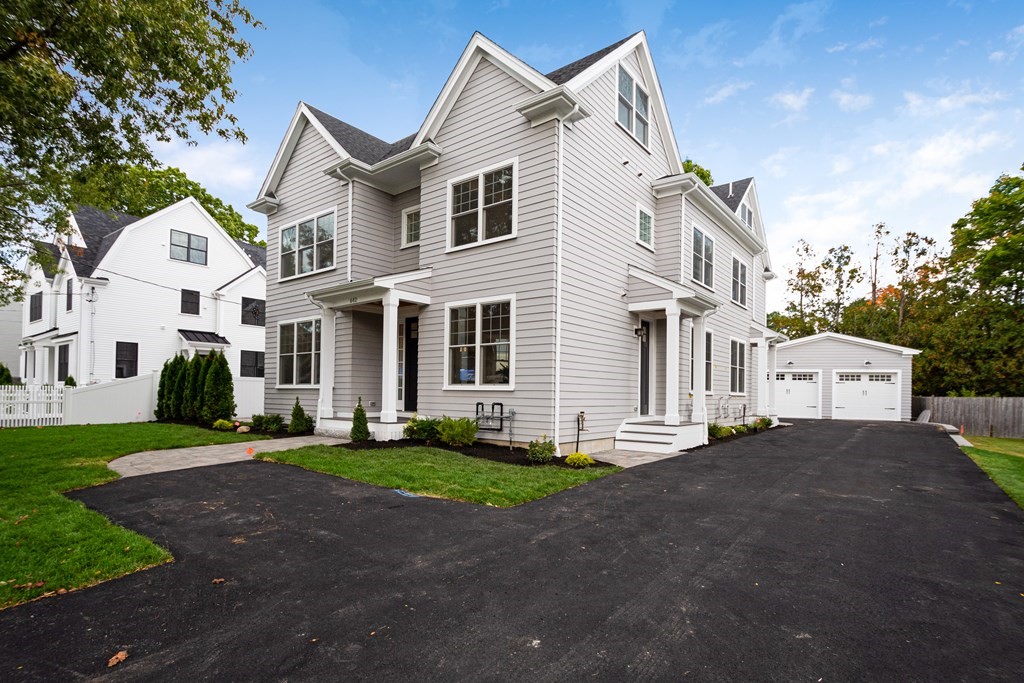 638 Webster Street, Unit 638 Needham, MA 02492 - Photo 1 of 29 a front view of a house with a yard and garage