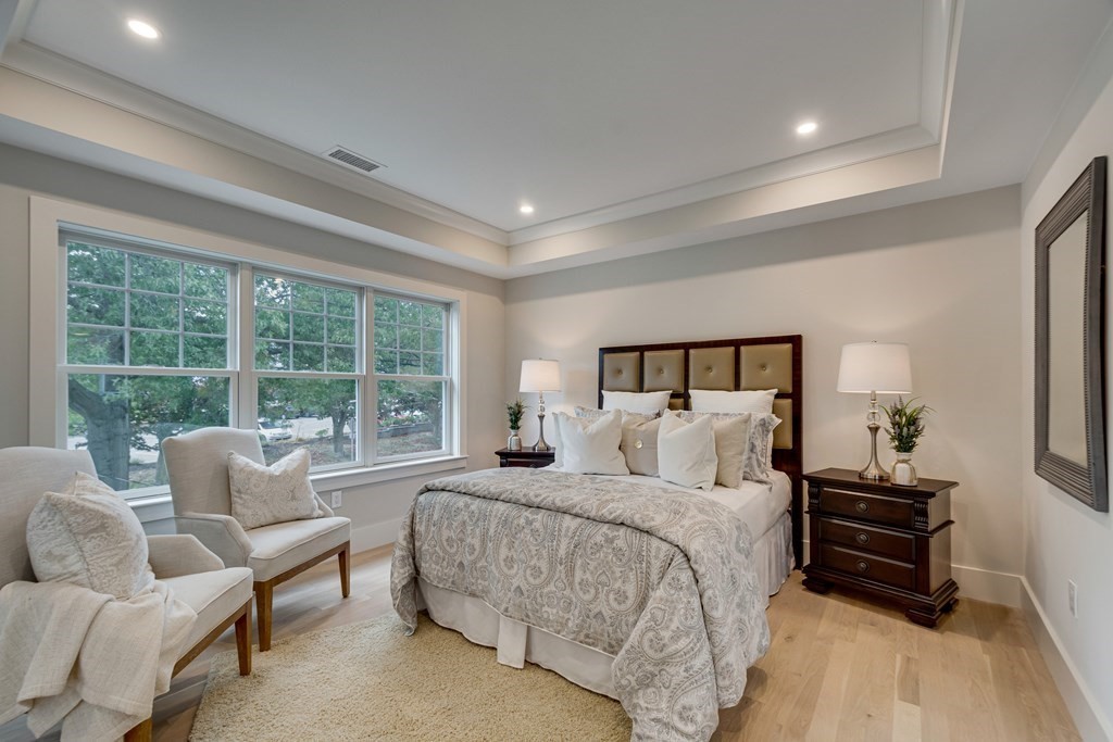 638 Webster Street, Unit 638 Needham, MA 02492 - Photo 12 of 29 a bedroom with a bed and a couch