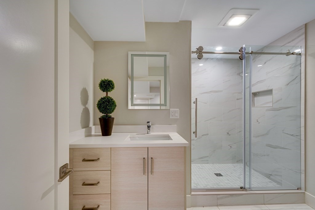 638 Webster Street, Unit 638 Needham, MA 02492 - Photo 17 of 29 a bathroom with a sink vanity and shower