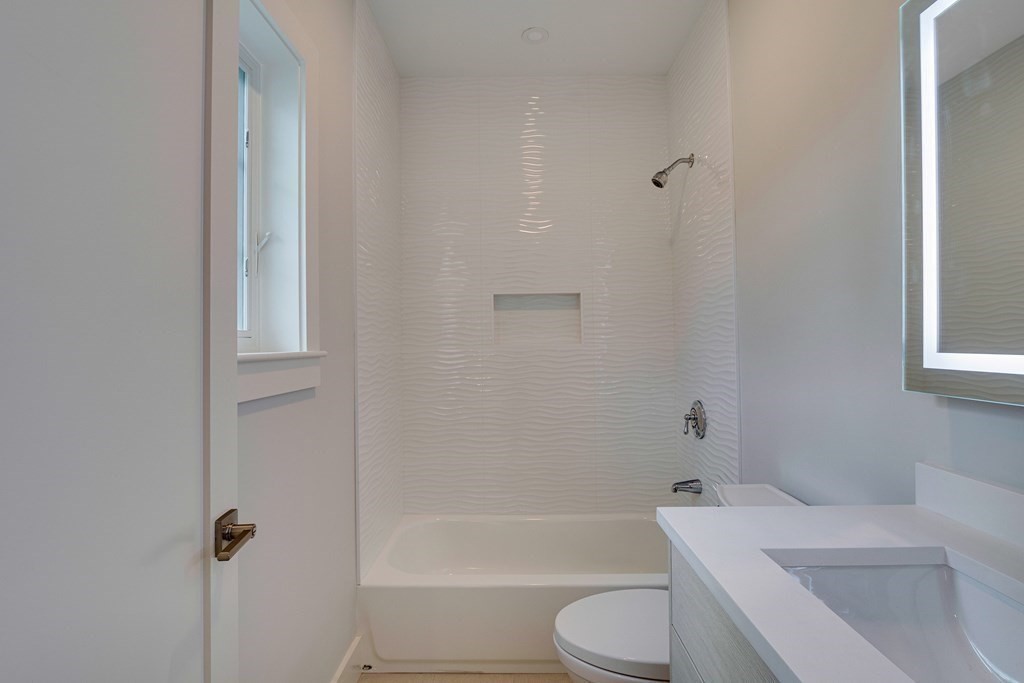 638 Webster Street, Unit 638 Needham, MA 02492 - Photo 18 of 29 a bathroom with a toilet and a bath tub